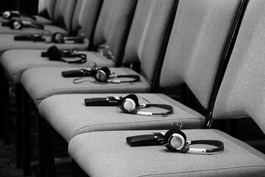 Row of interpretation headsets ready for conference attendees